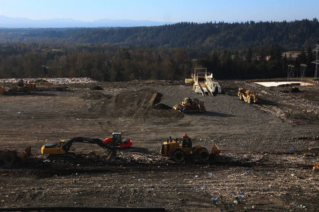 Solid Waste Division workers bring waste to Cell 8 of the landfill, working to flatten out the countys garbage. Photo by Bailey Jo Josie/Sound Publishing.