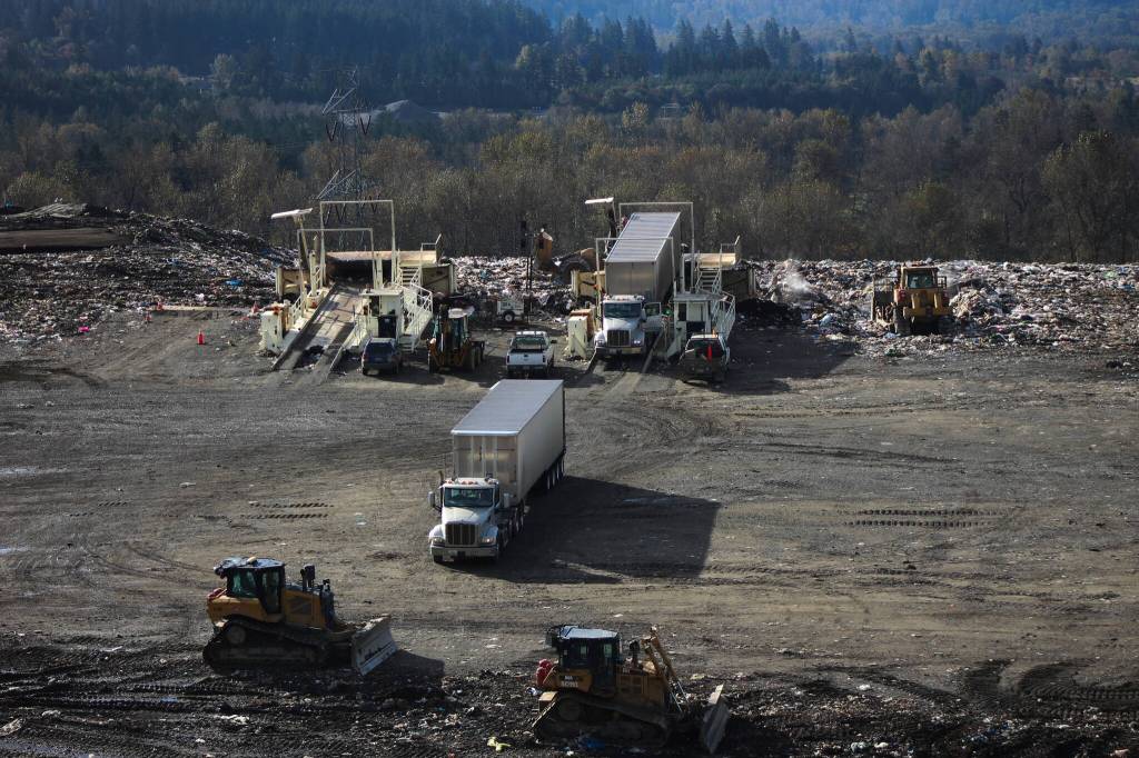 Trucks unload waste onto Cell 8. Photo by Bailey Jo Josie/Sound Publishing.