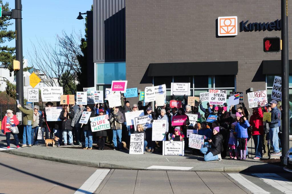 Fifty protesters held up a variety of signs at the Renton location for the Jan. 18, 2024 Womens March and Peoples March. Photo by Bailey Jo Josie/Sound Publishing.