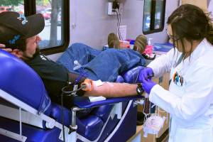 A mobile center from Bloodworks Northwest takes blood from Enumclaw resident Andy Bremmeyer, pictured in this 2019 photo. Sound Publishing file photo