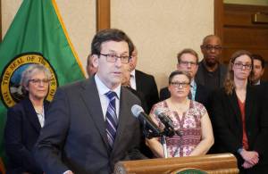 Gov. Bob Ferguson speaks to reporters at the state Capitol on Feb. 27 in Olympia about his plans to cut state spending by about $4 billion over four years. (Photo by Bill Lucia/Washington State Standard)