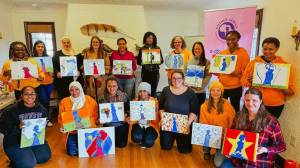 Painting the Mother Africa logo for the organizations 2025 Board Retreat. Courtesy photo.