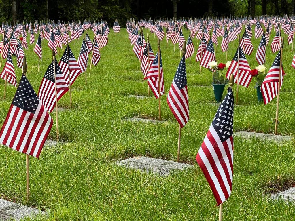 Small American flags adorn headstones at Tahoma National Cemetery in Kent. Photo Courtesy of Tahoma National Cemetery.