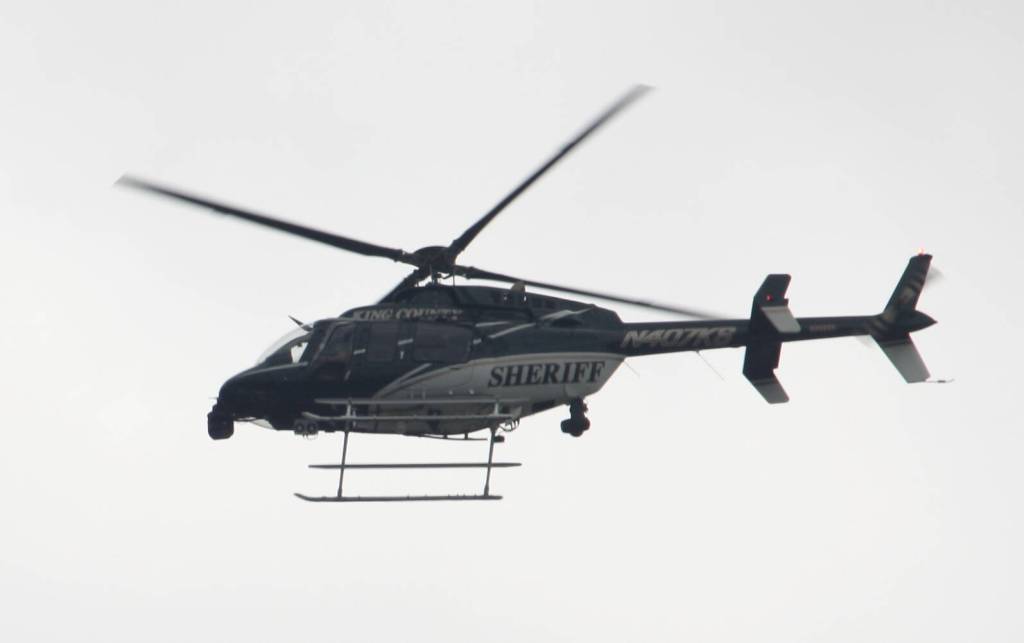 King County Sheriffs Office Guardian 1 helicopter flies over the No Kings protest in Covington. STEVE HUNTER, Kent Reporter