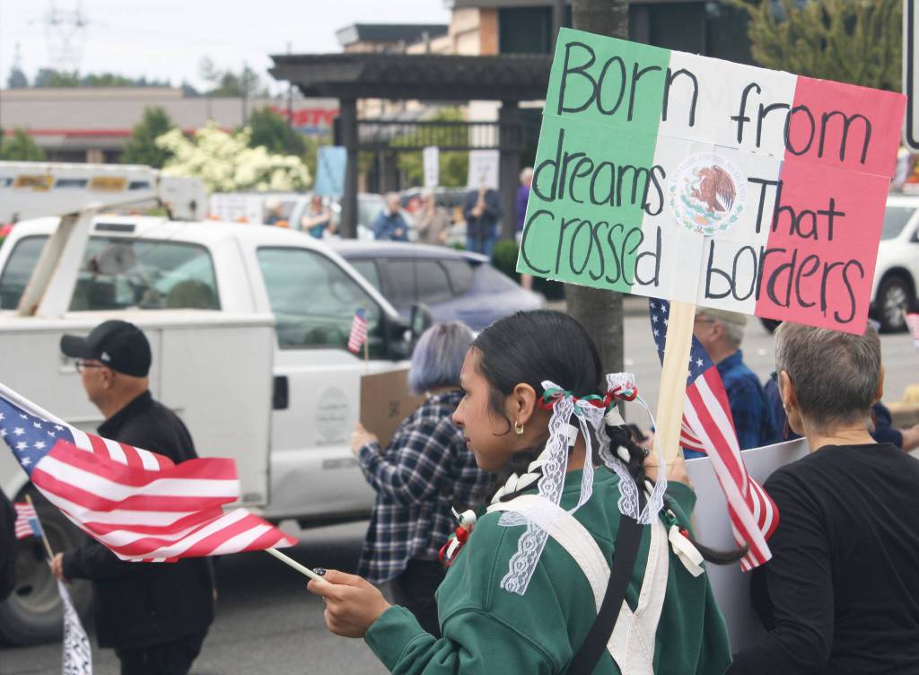 A woman protests along with about 1,500 others during a No Kings event Saturday, June 14 in Covington. STEVE HUNTER, Kent Reporter