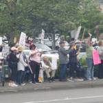 People wave signs in Covington and many drivers honk their horns in support. STEVE HUNTER, Kent Reporter