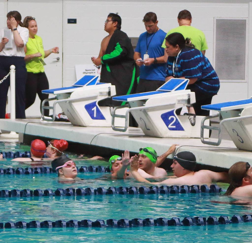 Special Olympics athletes high-five each other after a swim relay race at the 2025 Spring Games at the Weyerhaeuser King County Aquatic Center in Federal Way. The aquatic center is among recreational facilities and parks across the region that would receive upgrades with the passage of the King County Parks Levy on the Aug. 5 primary ballot. (File photo)