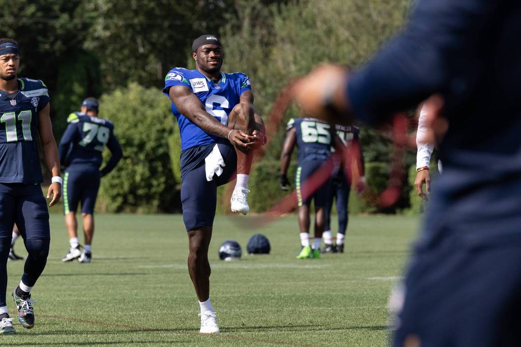 Jalen Milroe stretches during the team warm up at training camp. Photo provided by Maria Dorsten.