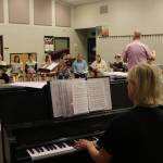 Rainier Youth Choirs founder Leora Schwitters plays piano as director Brian Hoskins leads the Consonore ensemble. Photo by Bailey Jo Josie/Sound Publishing.