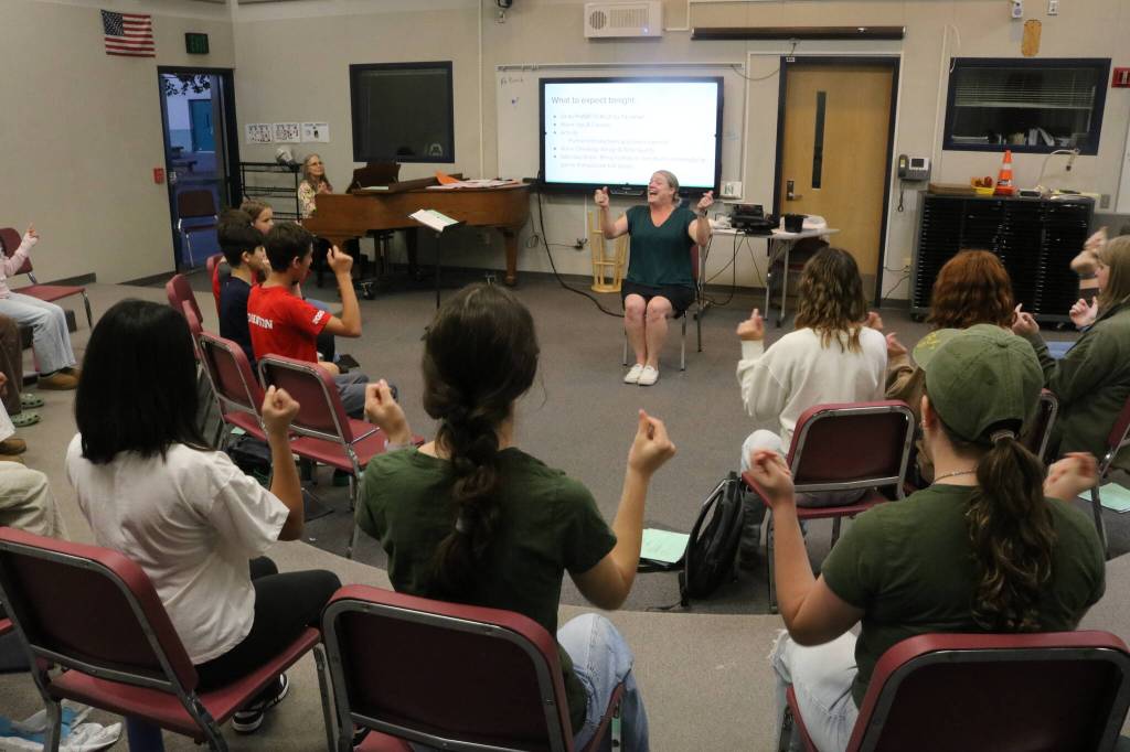 Colle Voce gets their voices and limbs ready to go during a Monday rehearsal. Photo by Bailey Jo Josie/Sound Publishing.