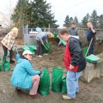 Maplewood residents and helpers fill up sandbag after sandbag at the county public sandbag station in the Highlands to keep the water from getting into their neighborhood on Dec. 11. Photo by Bailey Jo Josie/Sound Publishing.