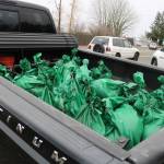 Pickup trucks and other vehicles have been traveling back and forth between the public sandbag station and the Maplewood neighborhood since 6 a.m. Dec. 11. Photo by Bailey Jo Josie/Sound Publishing