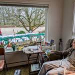 Jack Lyon, 94, sits in his chair and watches the Cedar River rush by only a meter from his window. Lyon, who has been living in his Maplewood Neighborhood home since the late 1950s, told the Renton Reporter that he's been able to gauge the water levels by how much he can see of his patio barbecue, which has not been swept away. Photo by Bailey Jo Josie/Sound Publishing