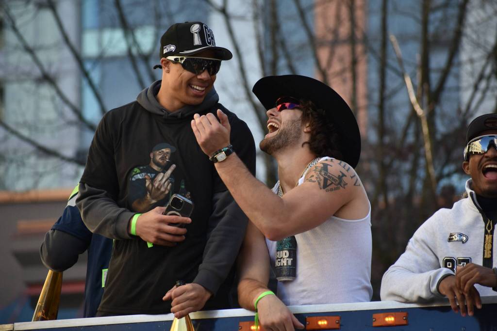Zach Charbonnet and AJ Barner laugh during the Super Bowl parade. Photos by Ben Ray / Sound Publishing