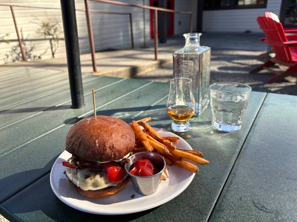 Hollywood Taverns burger, sweet potato fries and whiskey on the patio. Photo by Mindy Stern